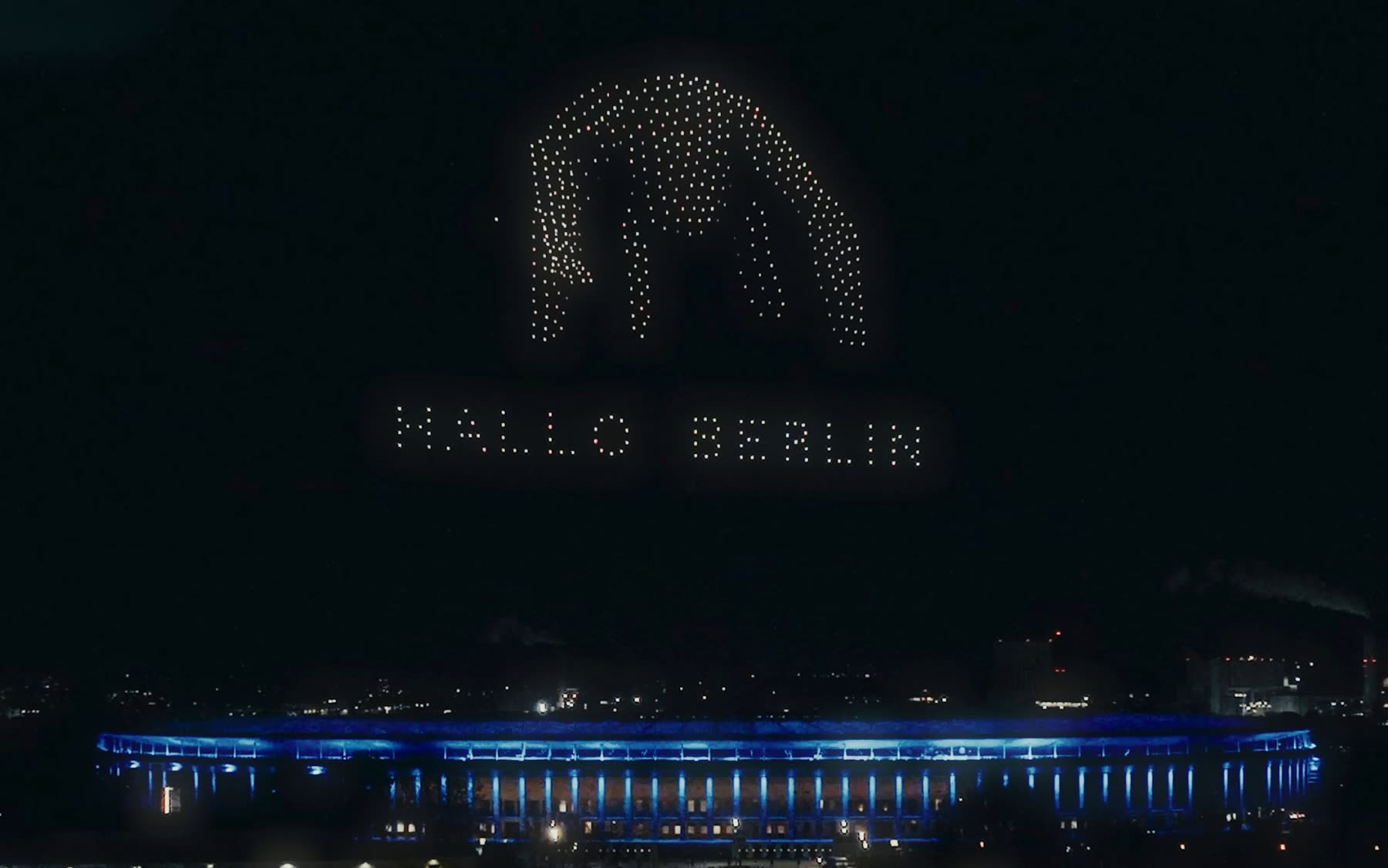 Drones spelling HALLO BERLIN beneath a giant illuminated bear above the Olympiastadion